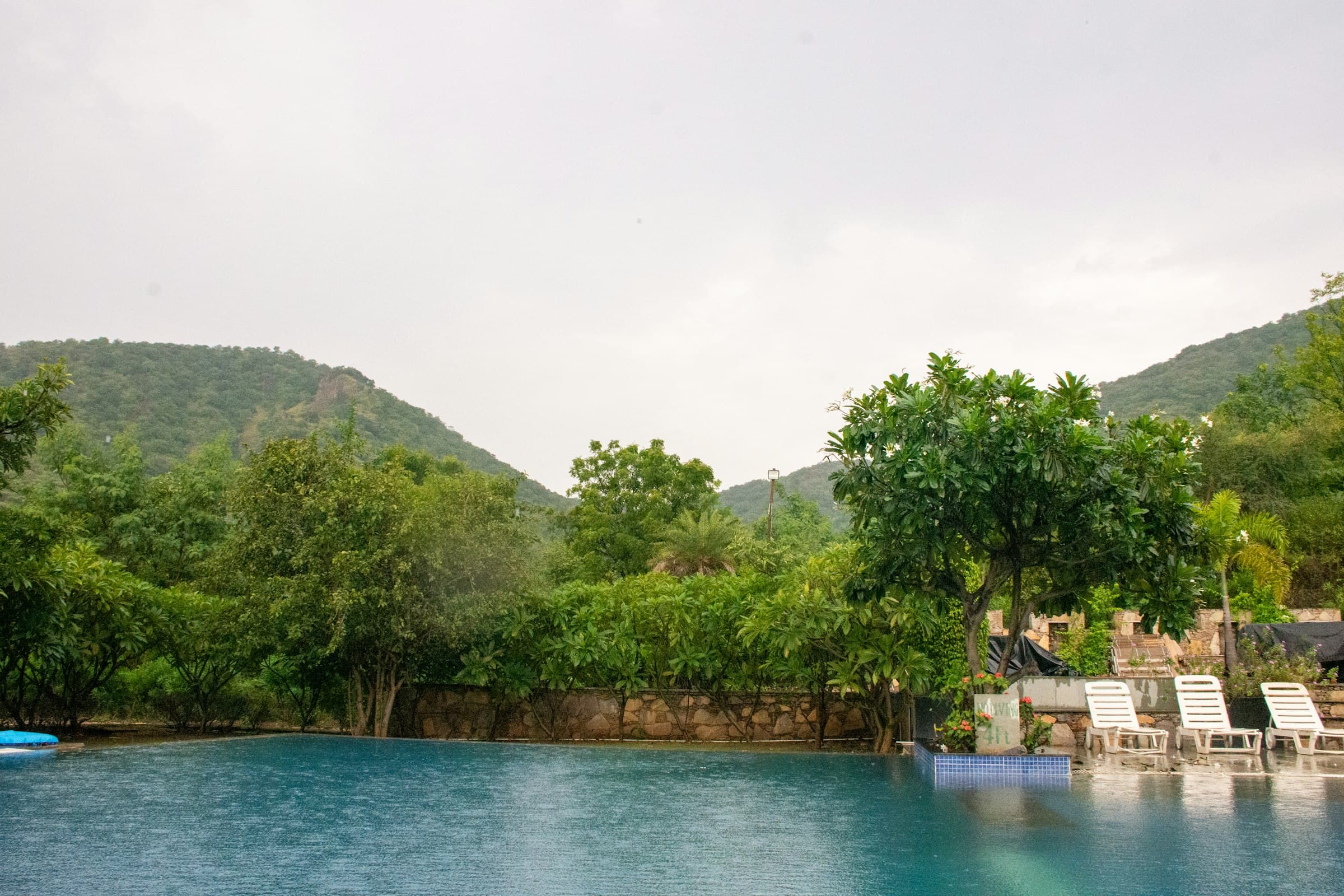Infinity pool at a resort facing green hills